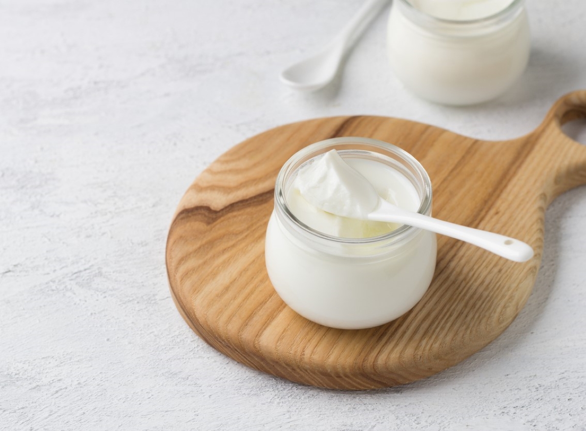 Greek yogurt in jar with spoon.