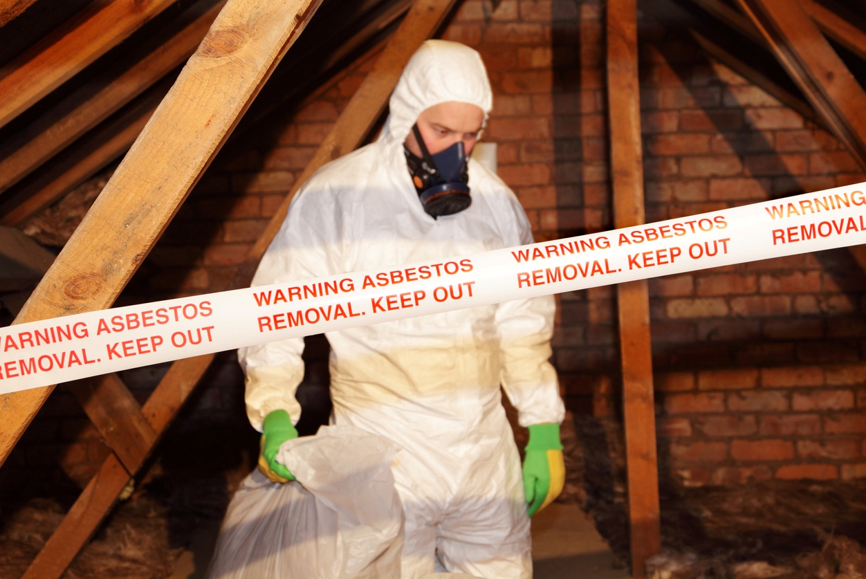 Professional cleaning asbestos in attic.