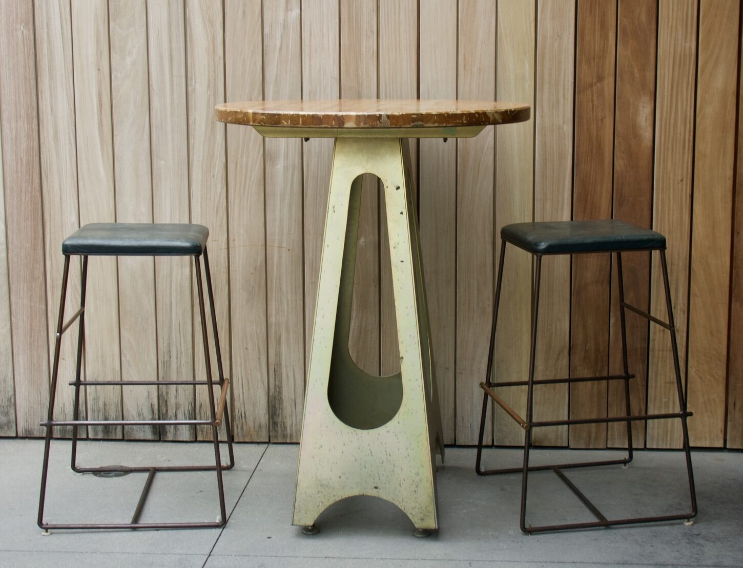 A small high-top dining table with bar stools.