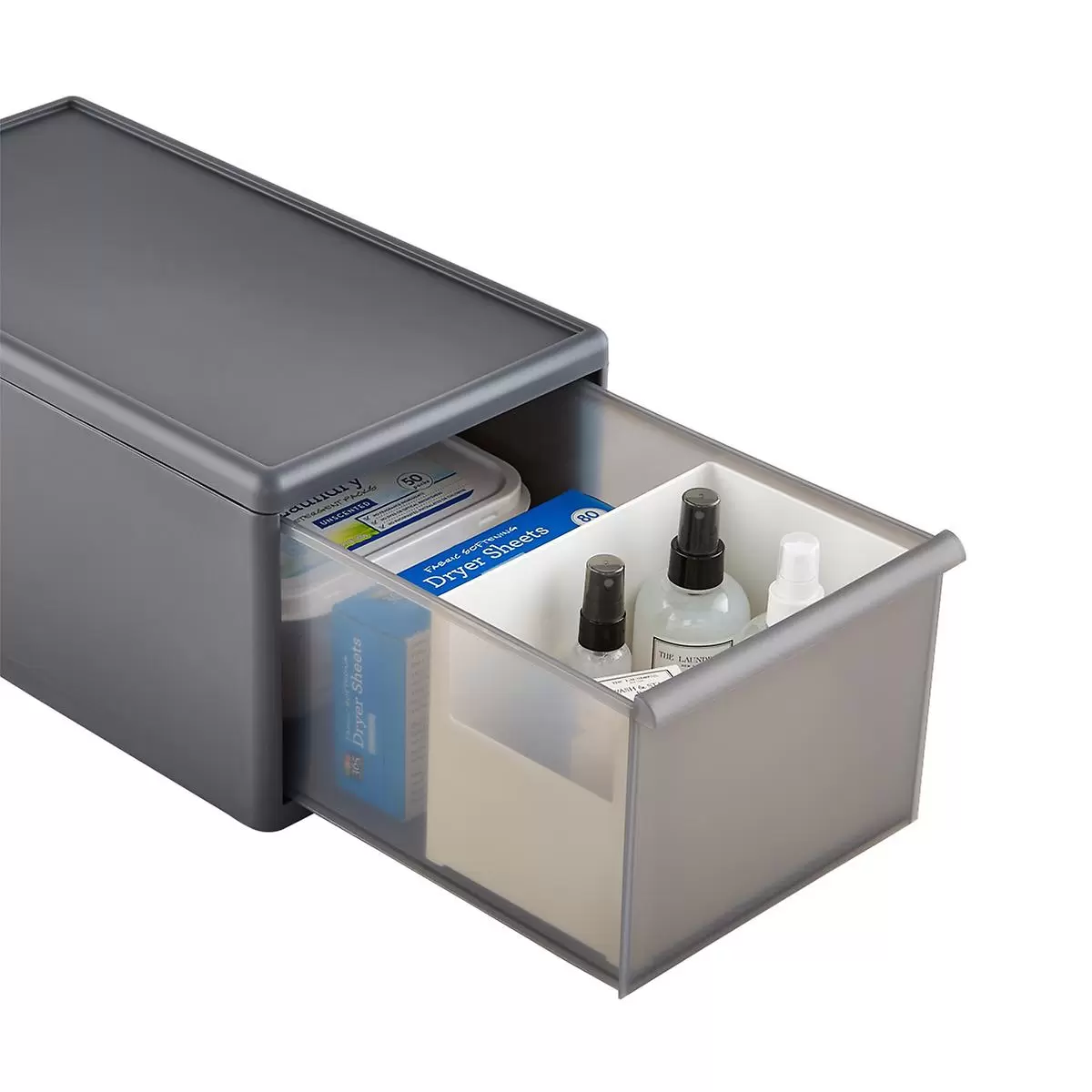 A grey plastic storage drawer contains laundry and cleaning supplies.