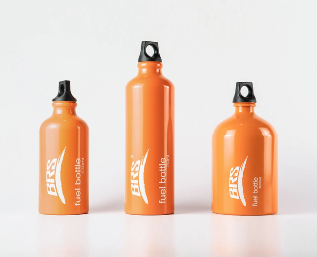 Three orange fuel bottles sit side by side on a white background.