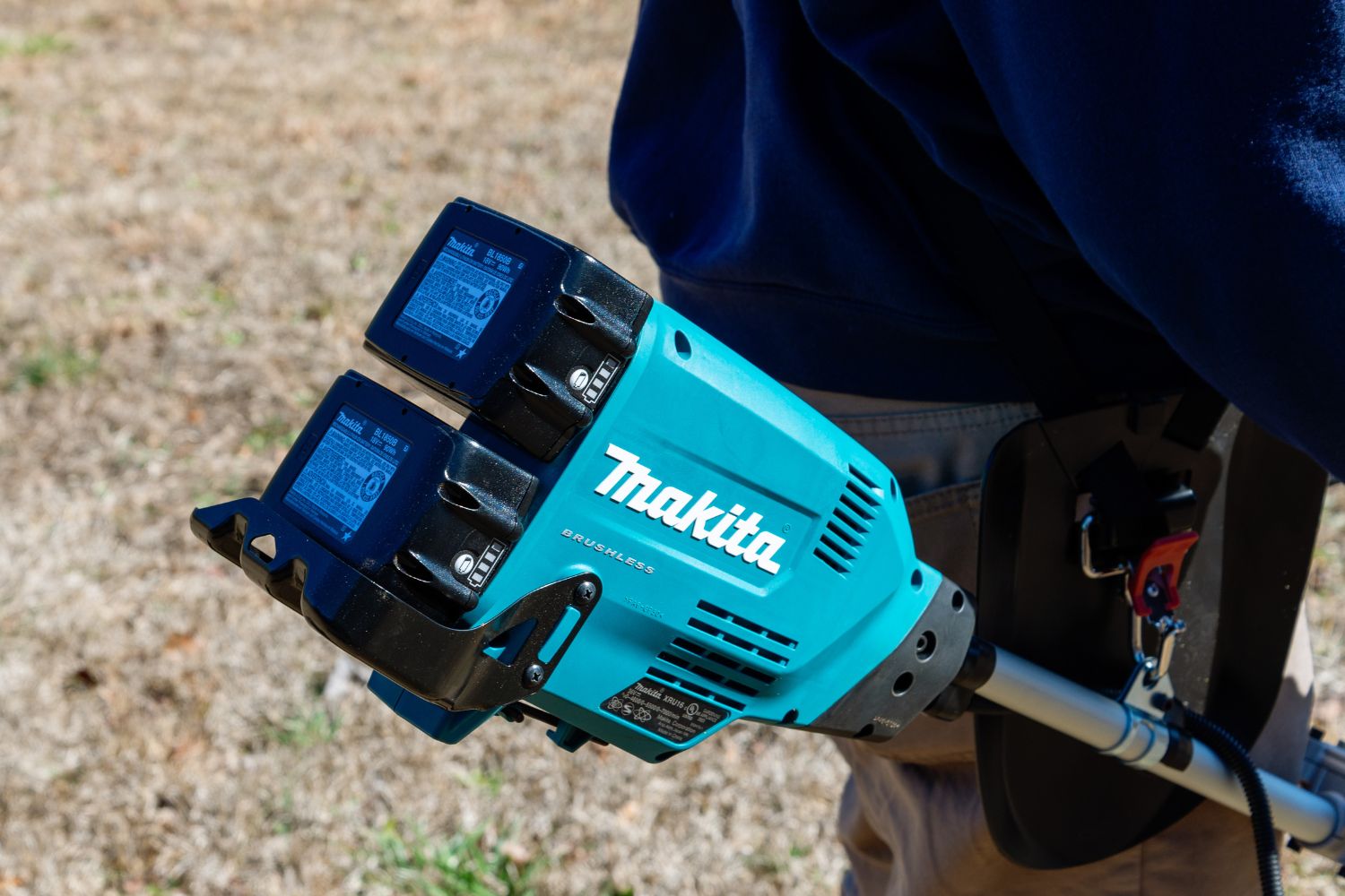 The dual-battery motor of the Makita cordless brush cutter outside during testing.