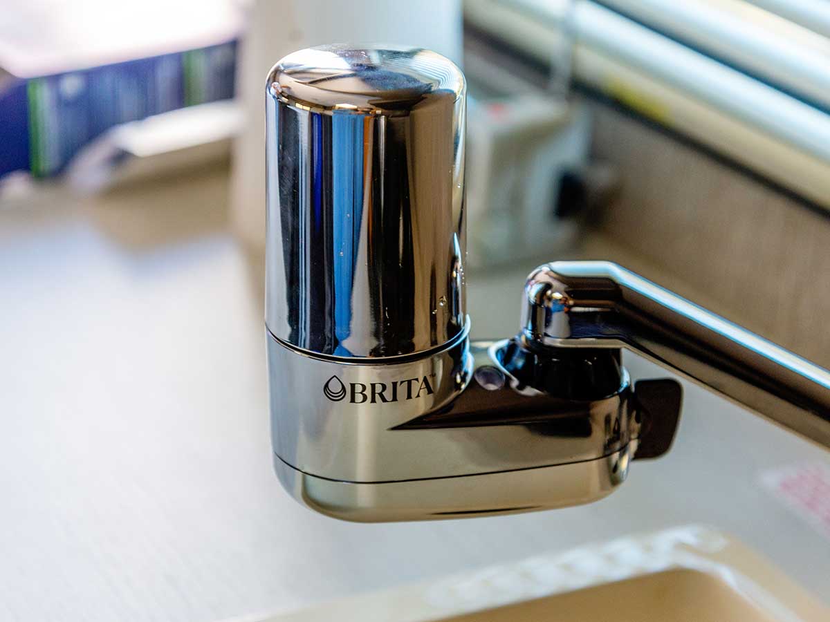 The Brita Complete water faucet filter installed on a kitchen faucet for testing drinking water taste and purity.