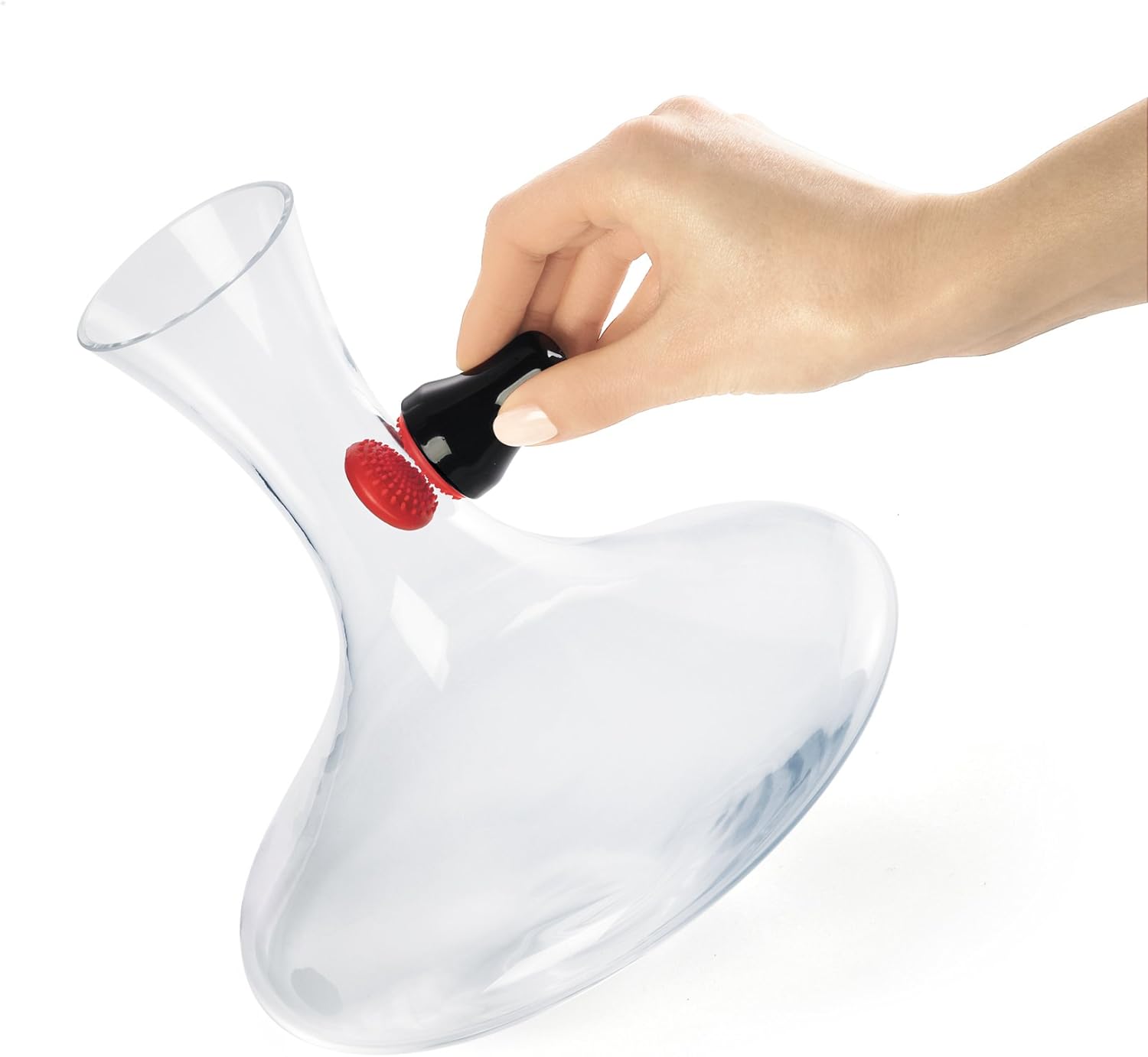 A hand uses the Cuisipro-Magnetic-Spot-Scrubber to clean the inside of a glass vase.