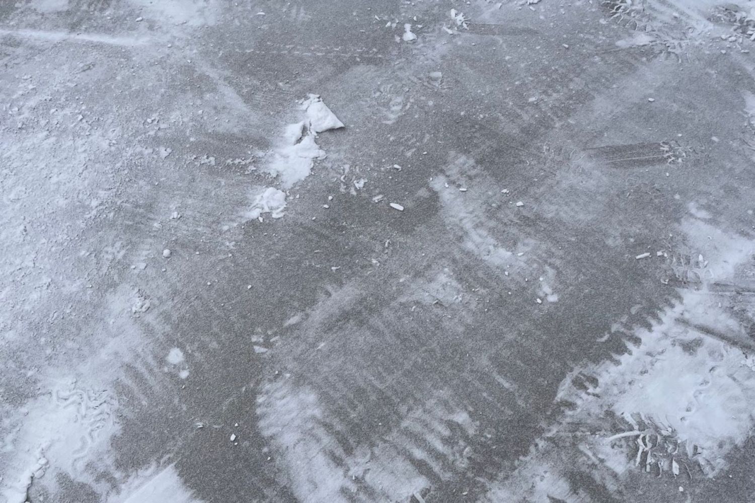 A driveway with very little snow on it after being cleared with the Ego lightweight snow blower.