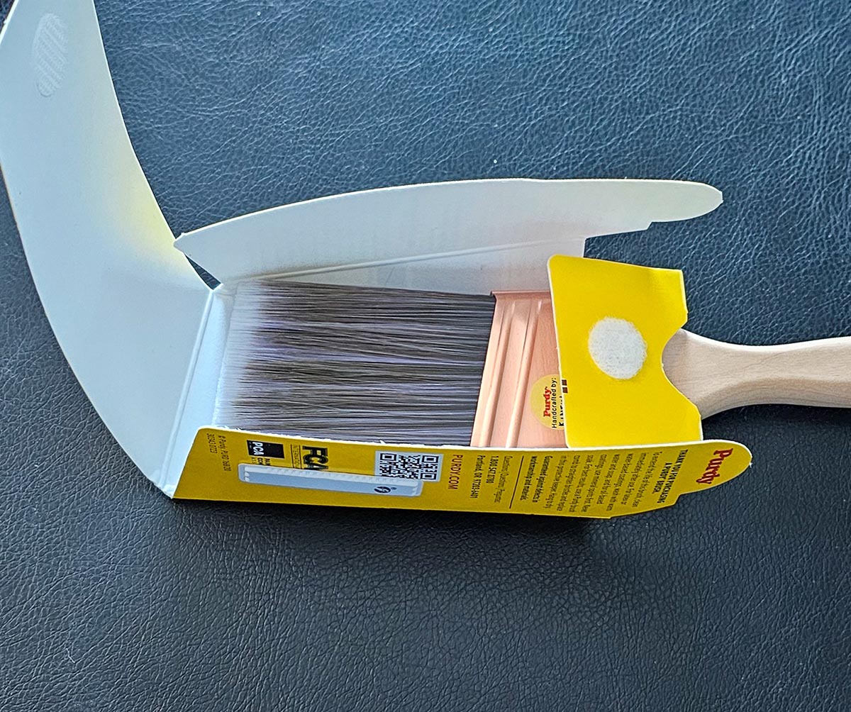 The Purdy 2-inch XL Glide paint brush inside its torn-open packaging.