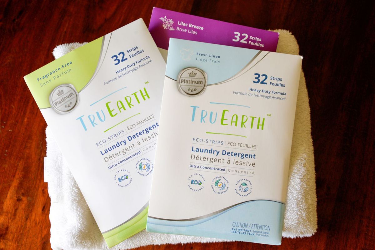 Several unopened packages of Tru Earth laundry sheets on a table before testing.