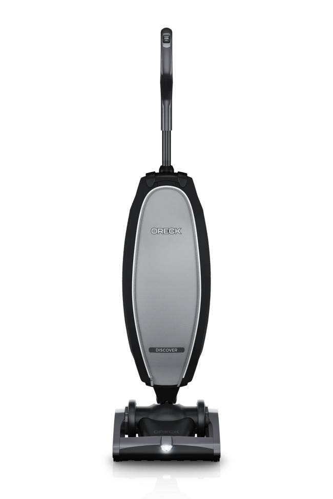 An Oreck upright vacuum in black sits against a white background.