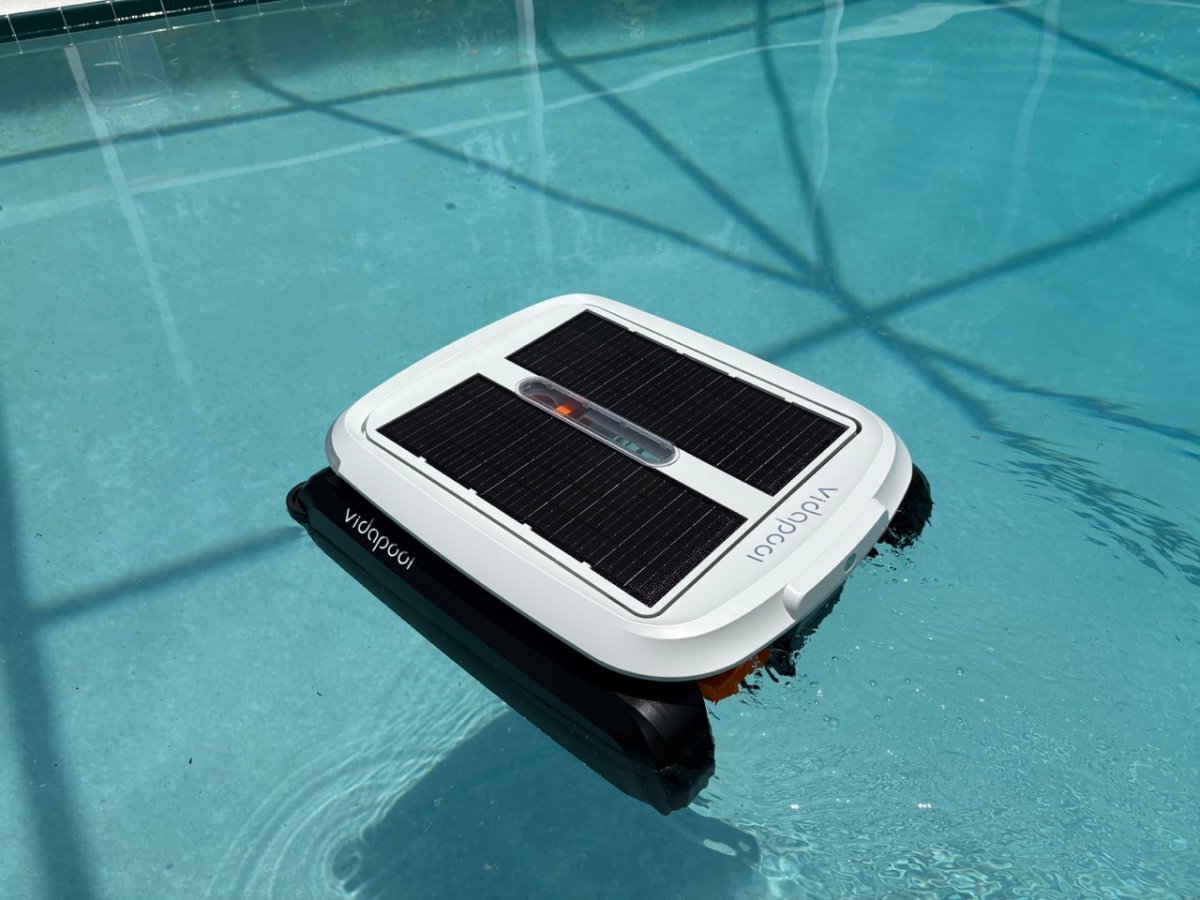 Robotic pool skimmer in use in pool
