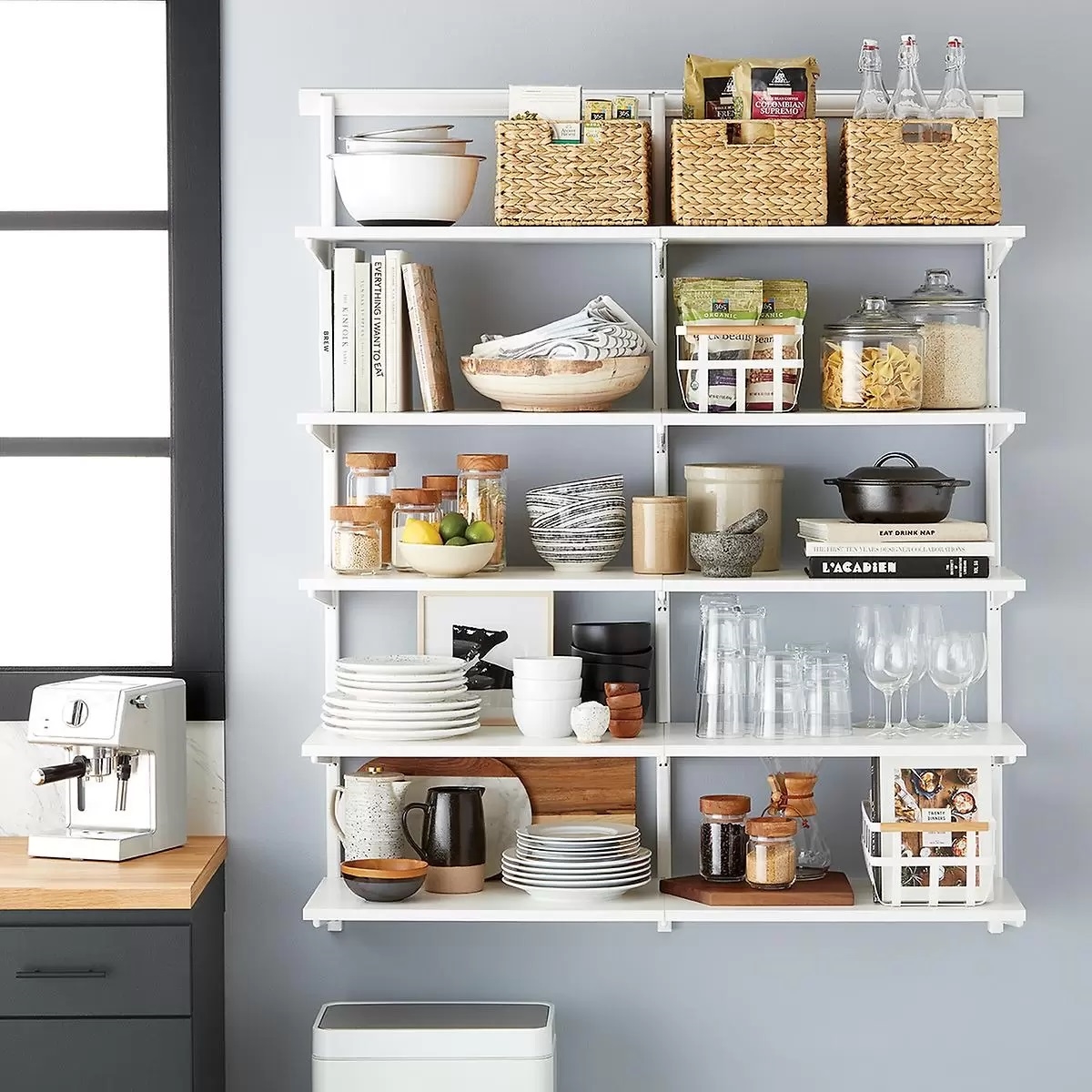 Open shelving with many items in kitchen.