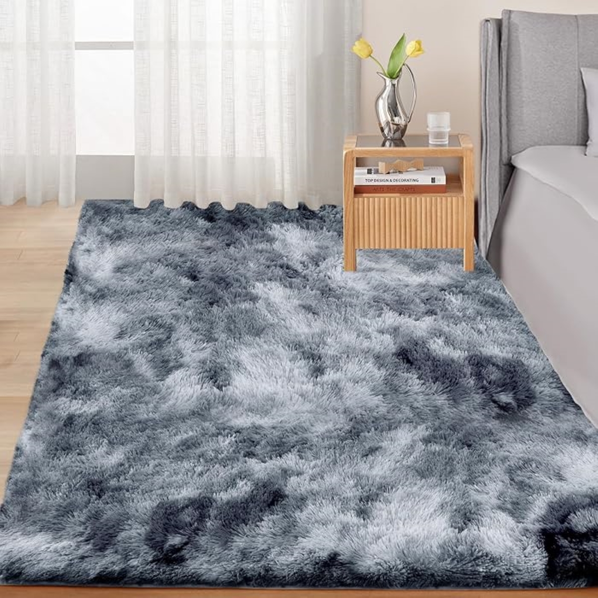 Gray fluffy area rug in bedroom.