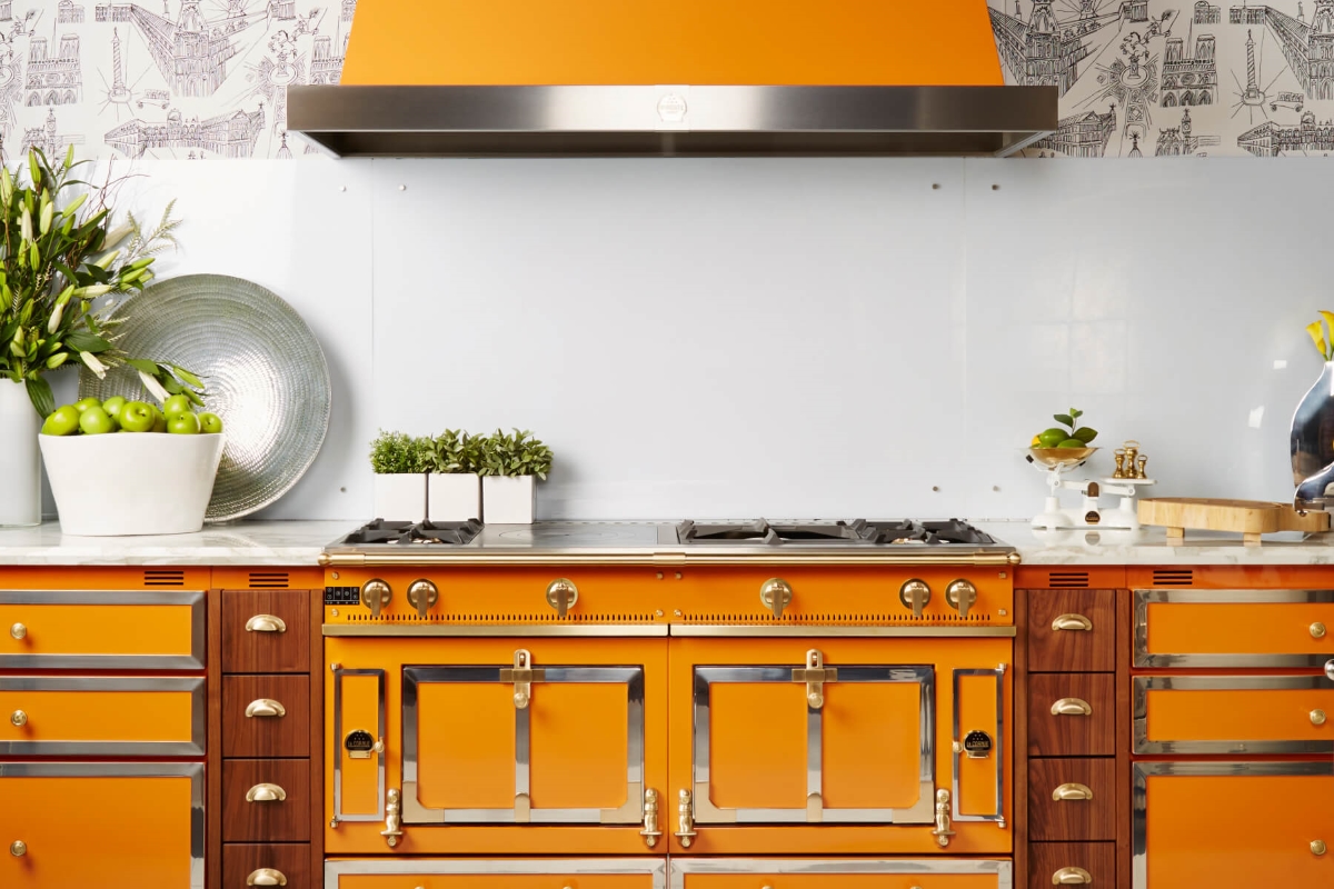Kitchen with matching orange and gold stove and cabinets.
