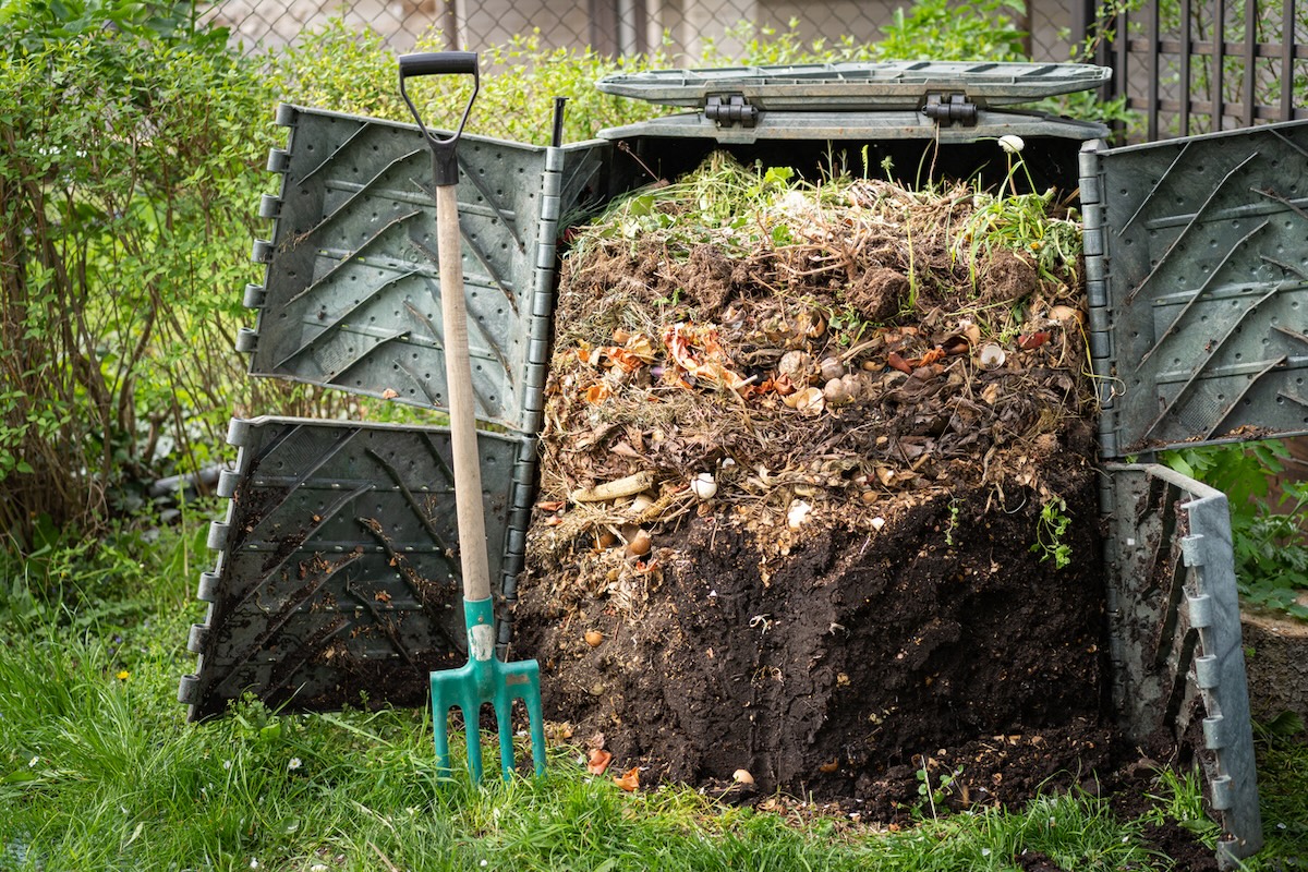 A large compost bin in a residential yard making humus for the lawn and garden.