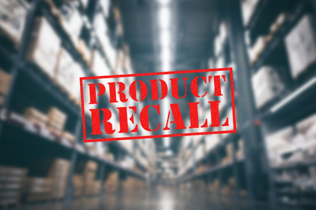 A-blurred-warehouse-aisle-is-the-background-for-a-Product-Recall-stamp-in-red.