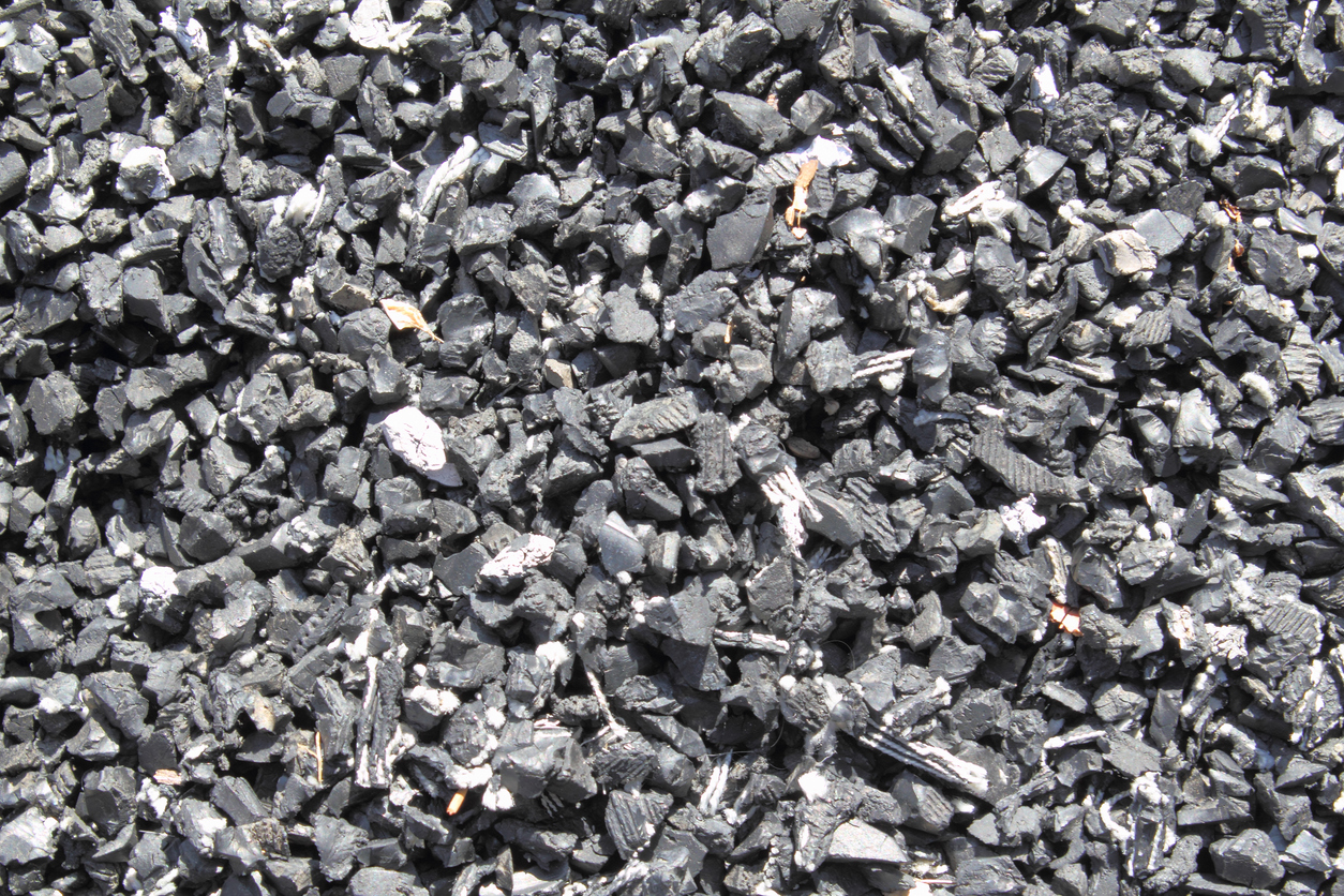Close up of dark grey rubber mulch.