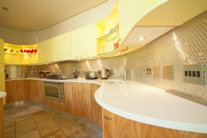Large kitchen with tiny shiny backsplash.