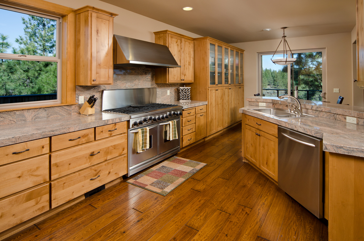 Kitchen with hardwood cabinets and stainless steel appliances.