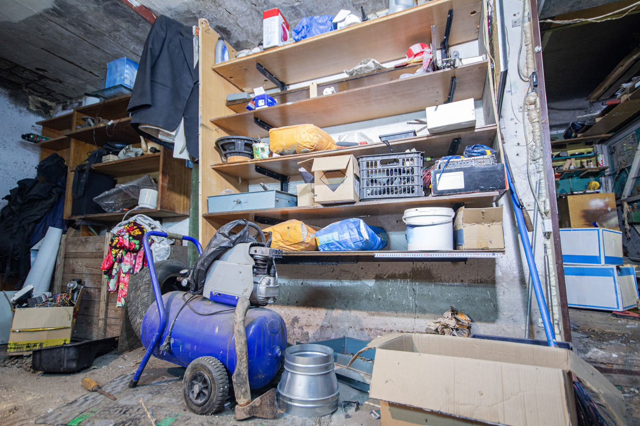 Home garage shelving with dusty products and machinery.