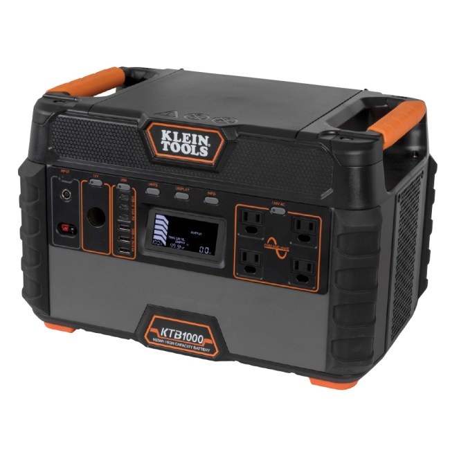 A portable power station in black with orange accents sits on a white background.