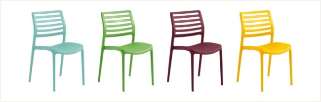 Four plastic side chairs are lined up in blue, green, maroon, and yellow.