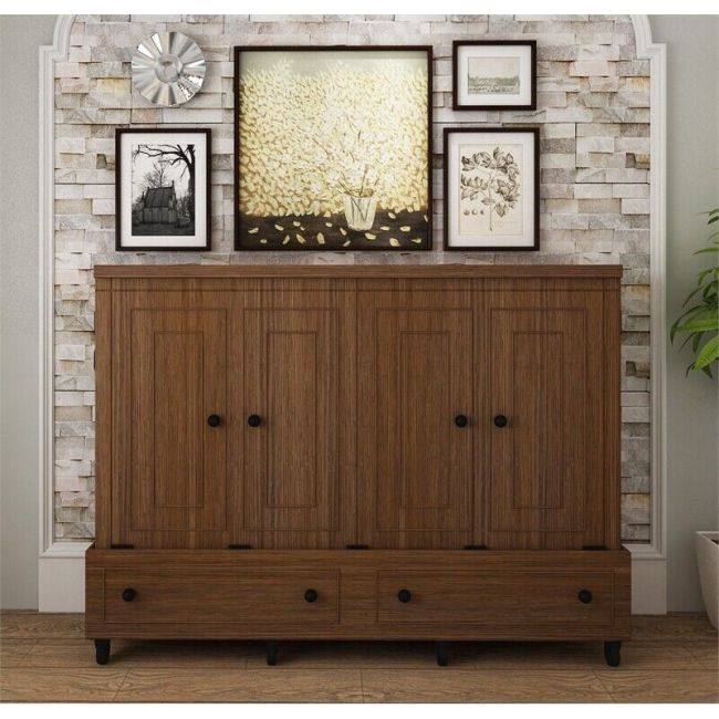 A hide-a-bed is closed in a wood cabinet and decorated against a textured beige wall.