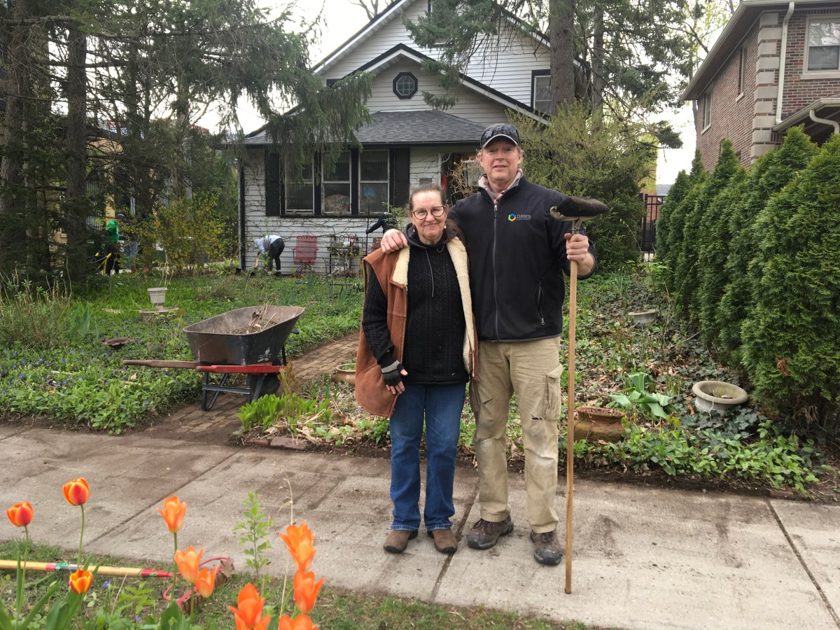 Volunteer of Rebuilding Together stands with Barbara Bischoff in front of her Illinois home.