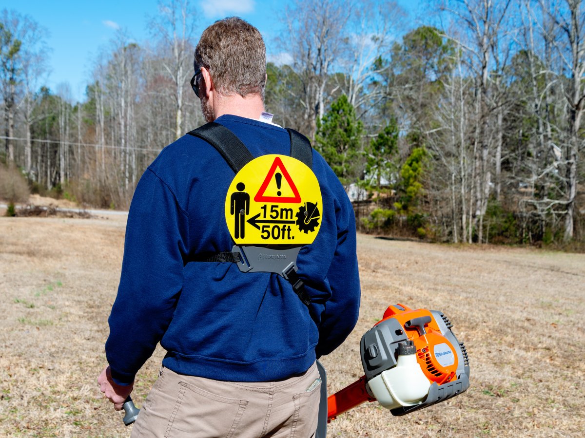 a man using one of the models of the best brush cutter