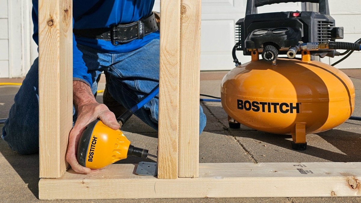 Bostitch Palm Nailer A person using the Bostitch PN100K Impact Nailer Kit to install framing during testing.