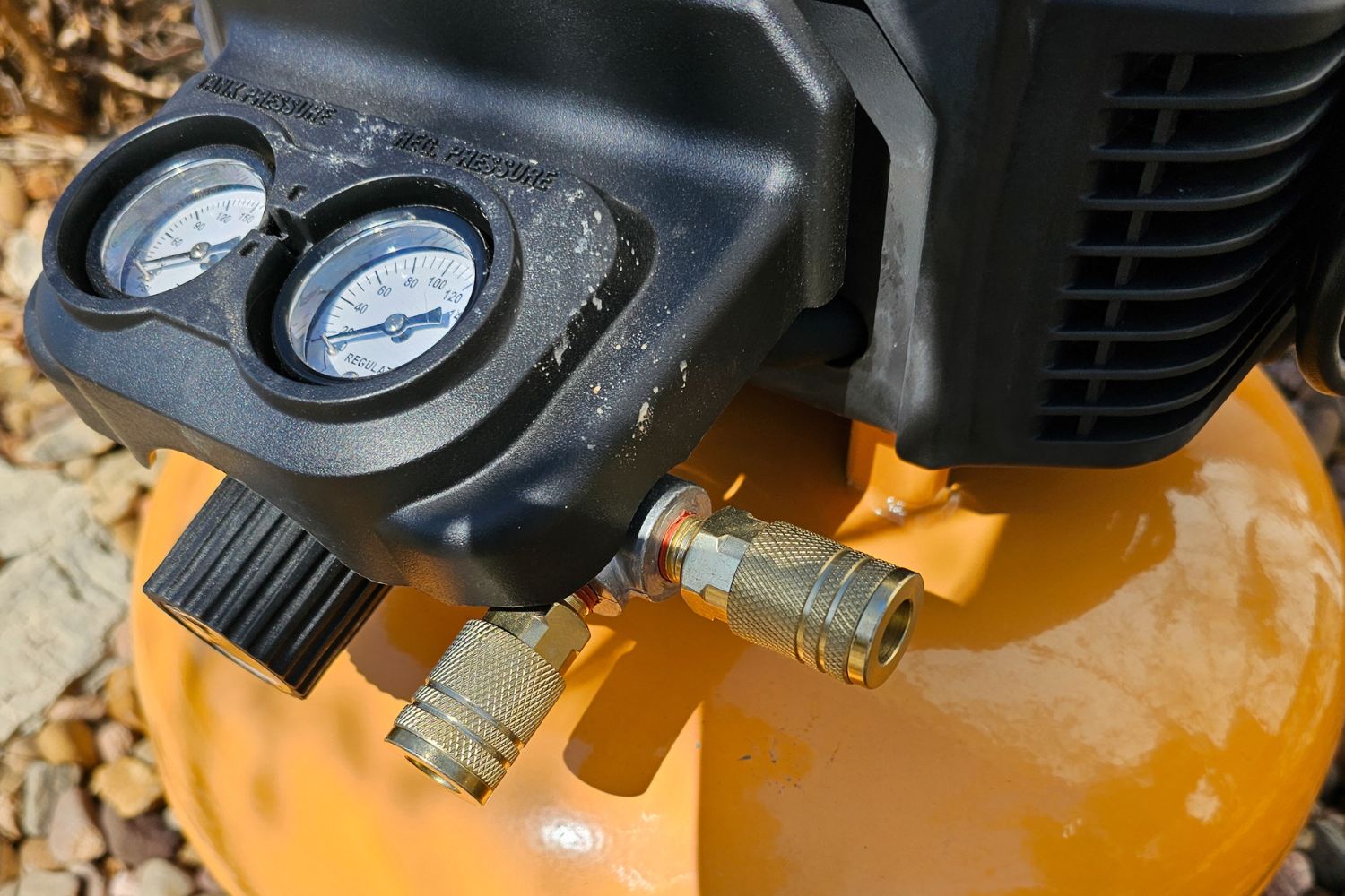 Pressure gauges and hose hookups on the Bostitch Air Compressor.