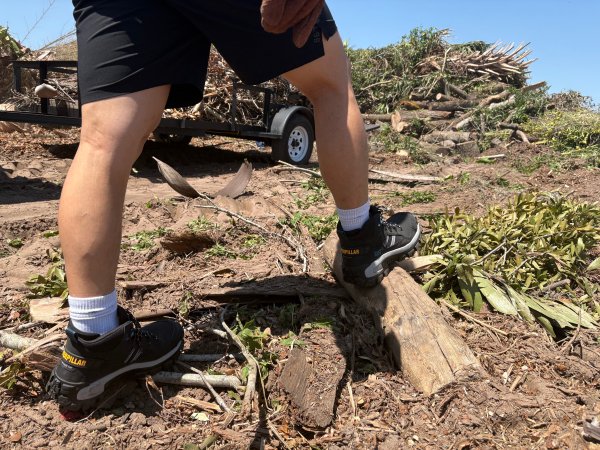 person wearing one of the best work boots walking up a trail