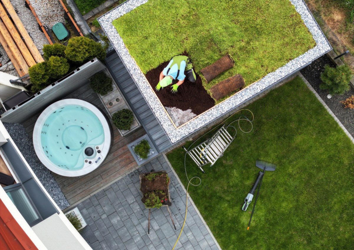An aerial view of a worker installing a green roof.