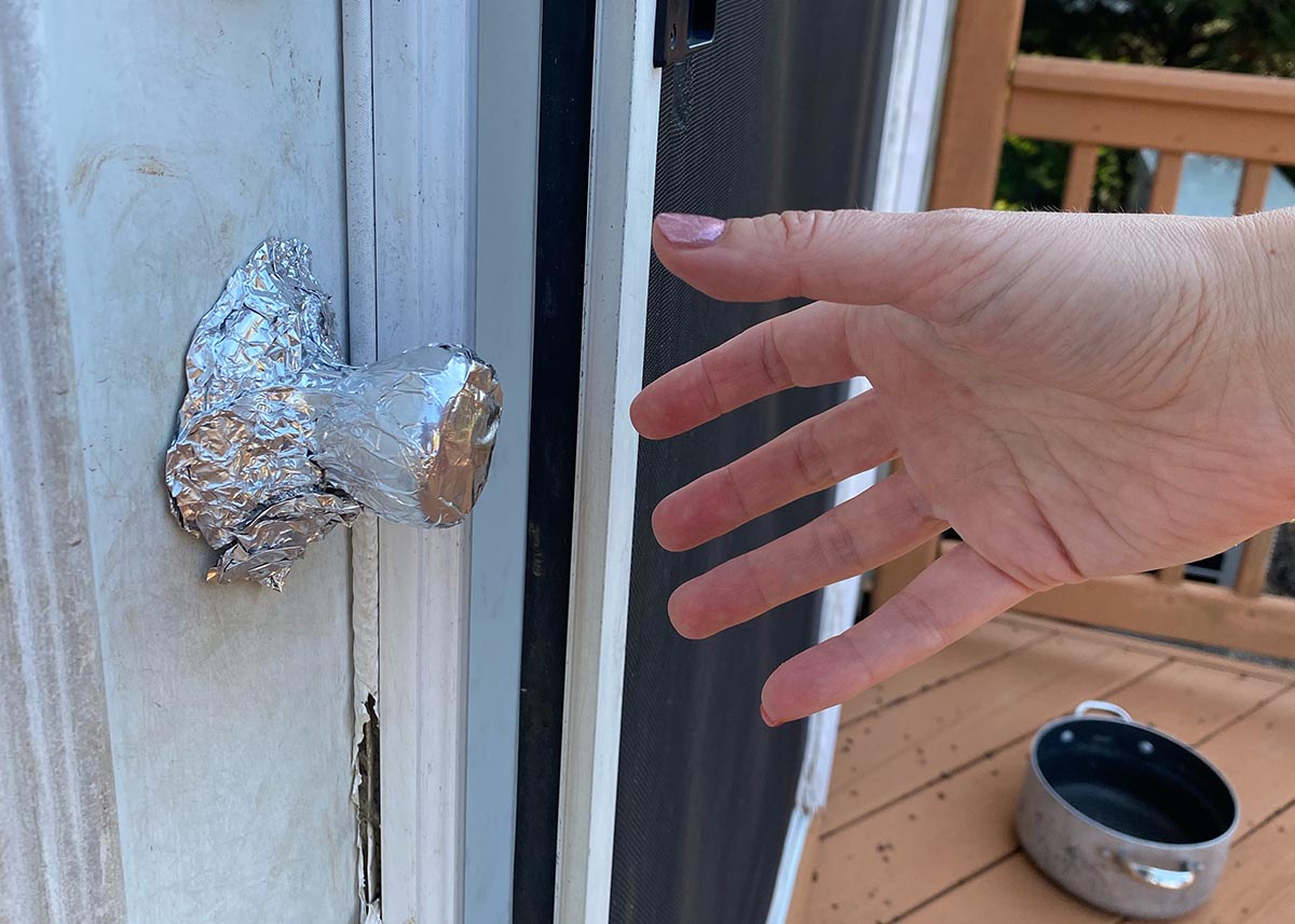 A hand reaches out to grab a handle covered in foil.
