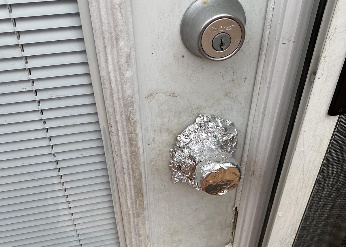 Aluminium foil covers a door knob.