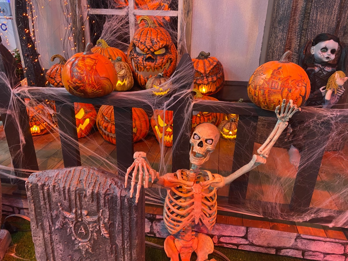 Giant skeleton surrounded by spooky pumpkins