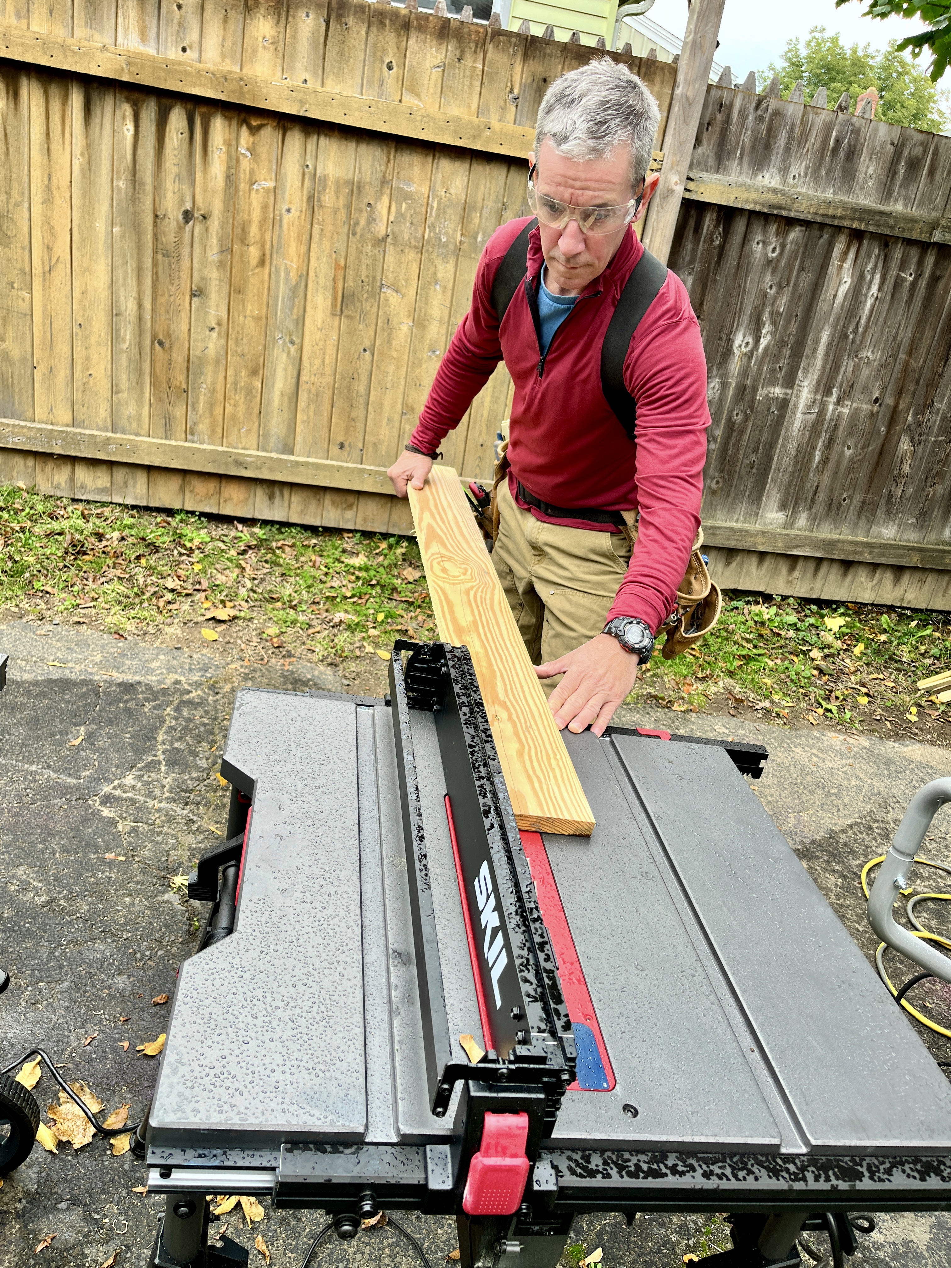 BobVila.com tester Mark Clement rips a board on a Skil portable table saw.