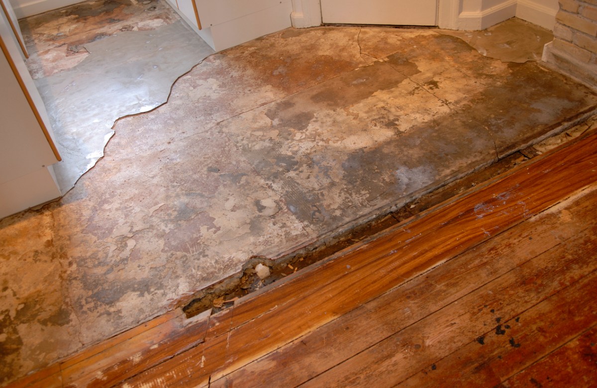 A close up of a floor in need of repair.