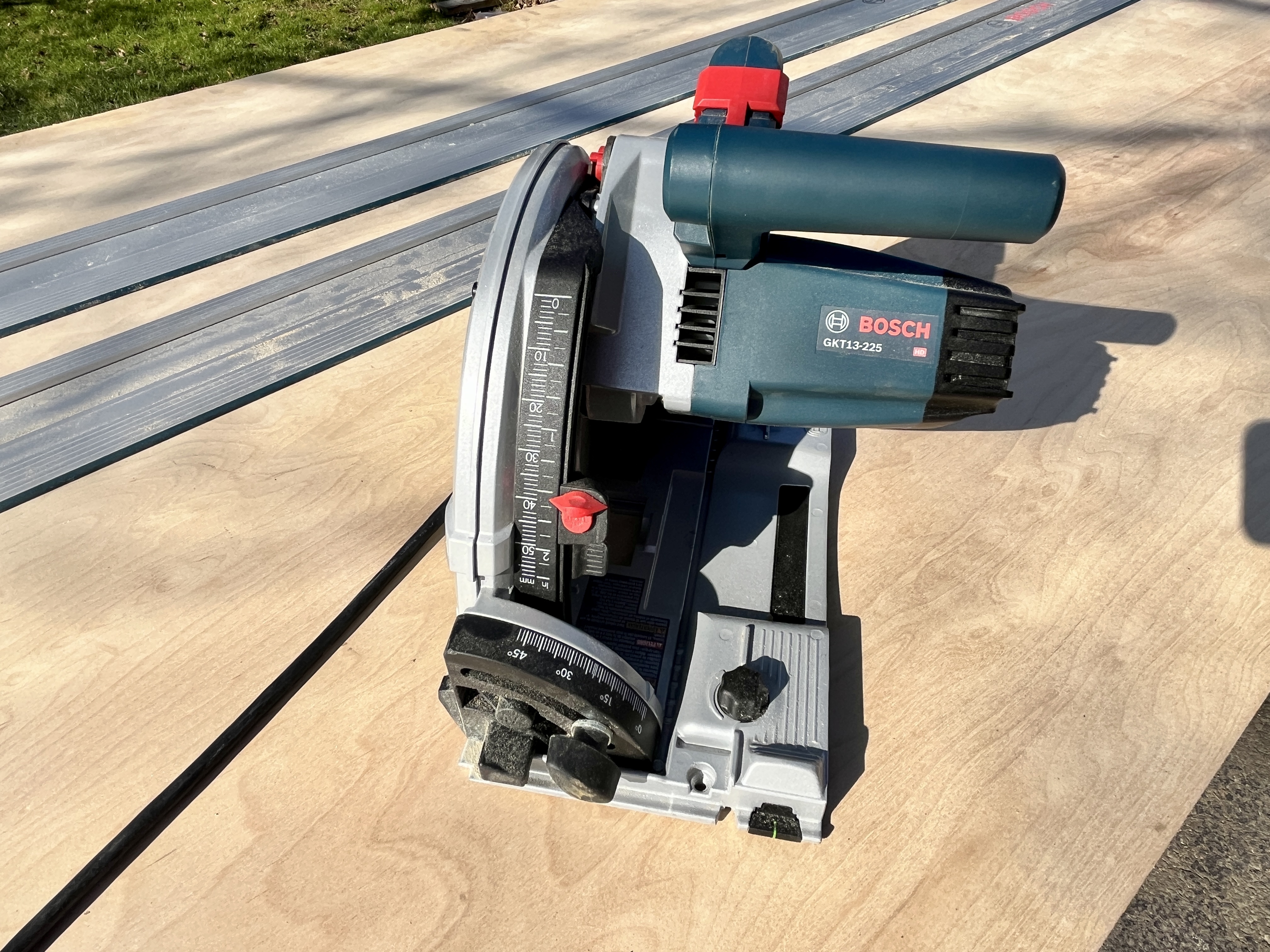 A Bosch track saw rests on plywood before testing.