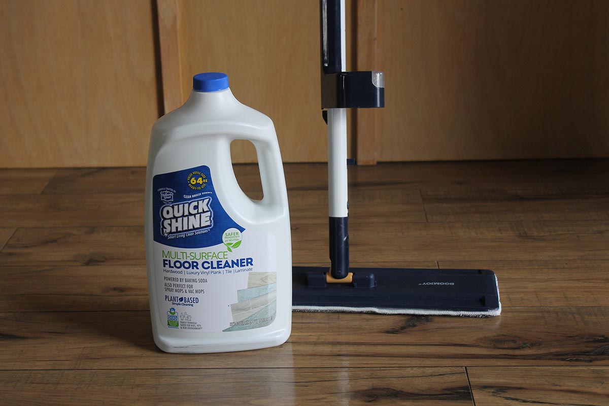 The Quick Shine Multi-Surface Floor Cleaner next to a mop during testing.
