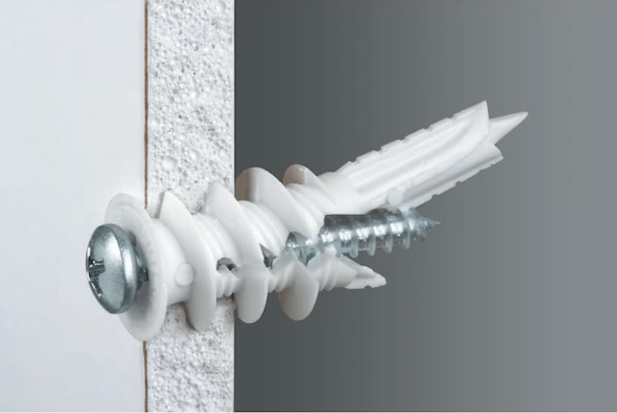 Threaded drywall anchor in wall from side view. 