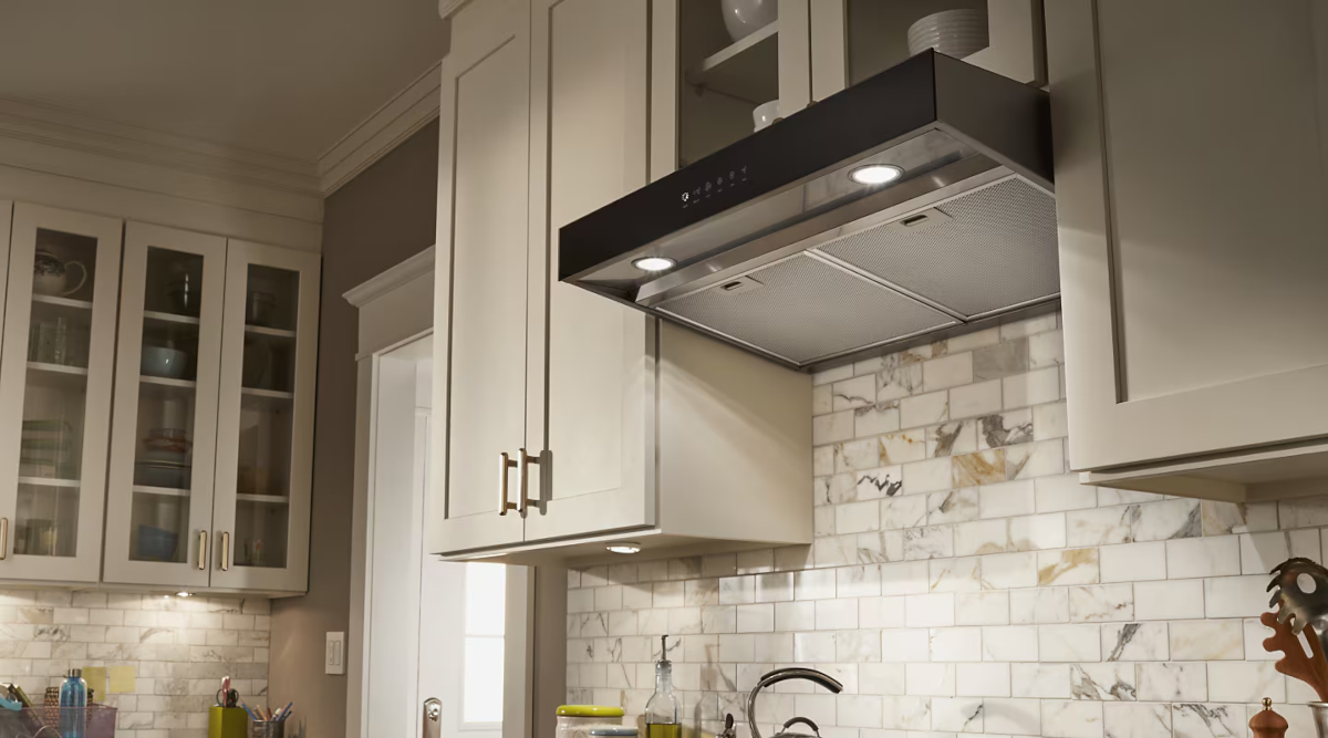 A white kitchen with an under-cabinet range hood.