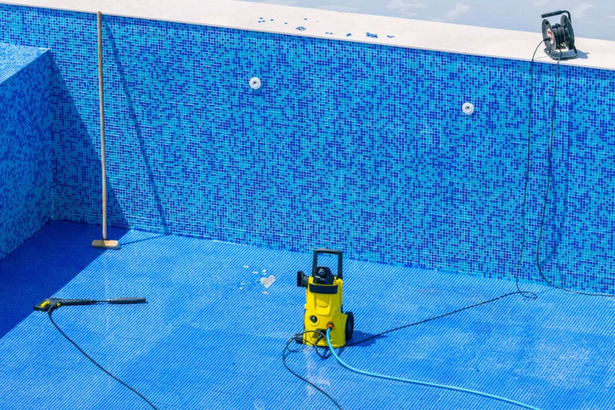A close up of a pool cleaner in a drained pool.