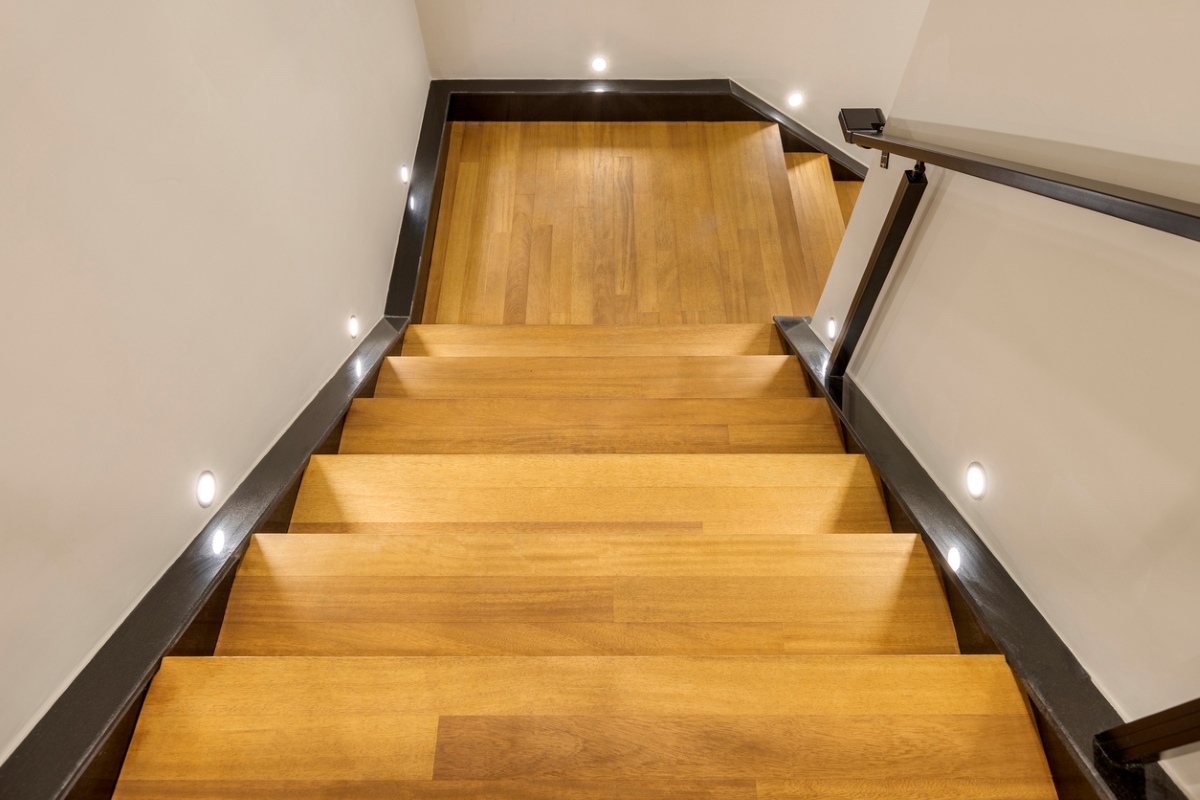 Hardwood stairs that turn 90 degrees to the right after a square landing.