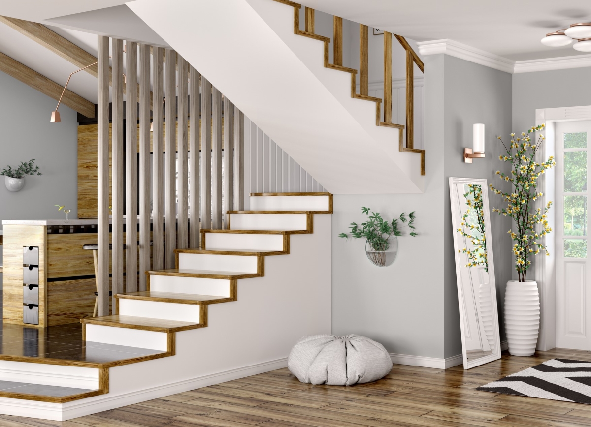 A white half-turn staircase with stained wood trim on each step and a matching banister.