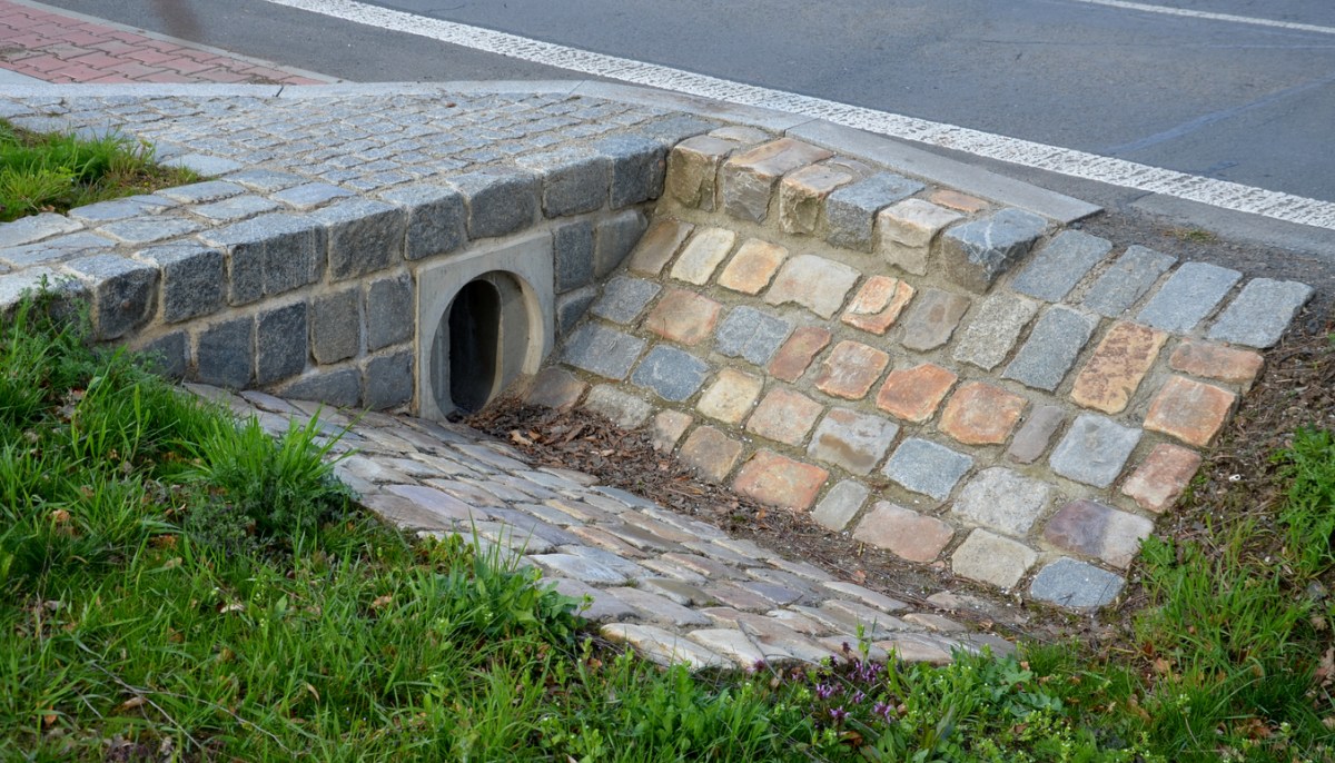 A-culvert-under-a-driveway-is-paved-with-stone.