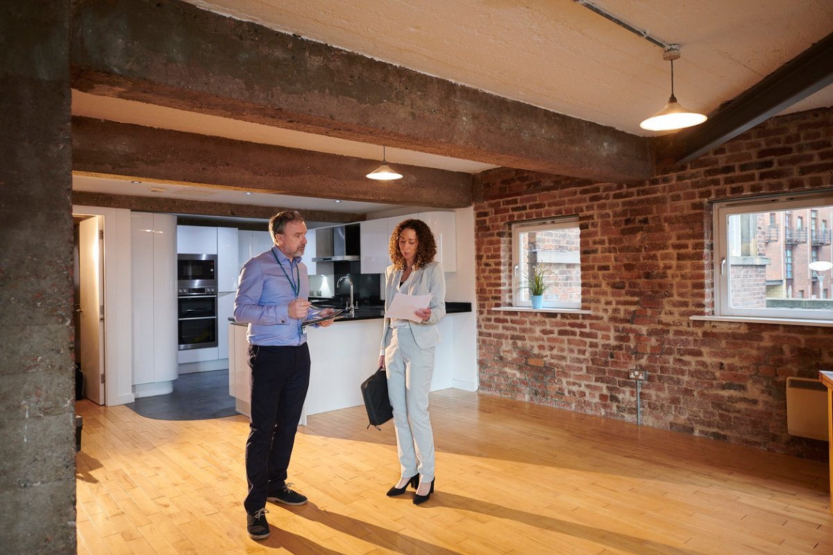 Two real estate professionals discuss a property.