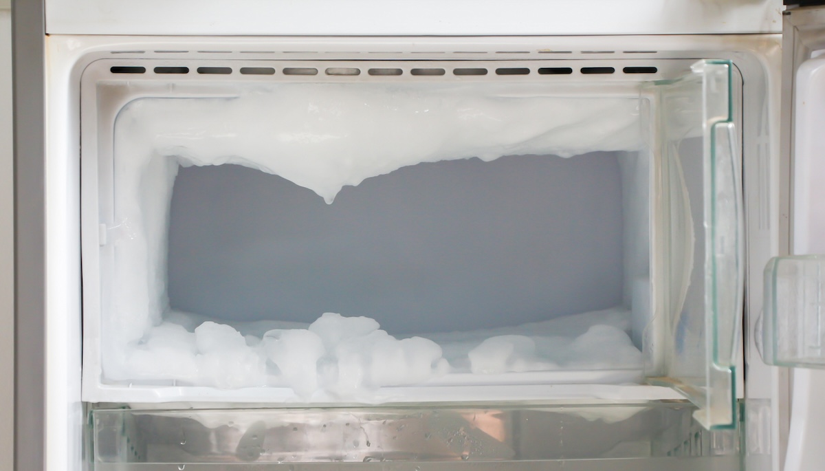 Freezer that is covered in frost and needs to be defrosted. 