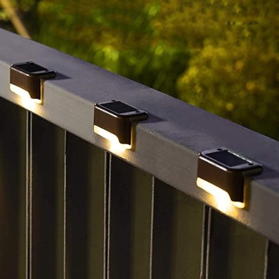 The Solpex Horizontal Warm White Solar Deck Lights Set installed on a deck railng.