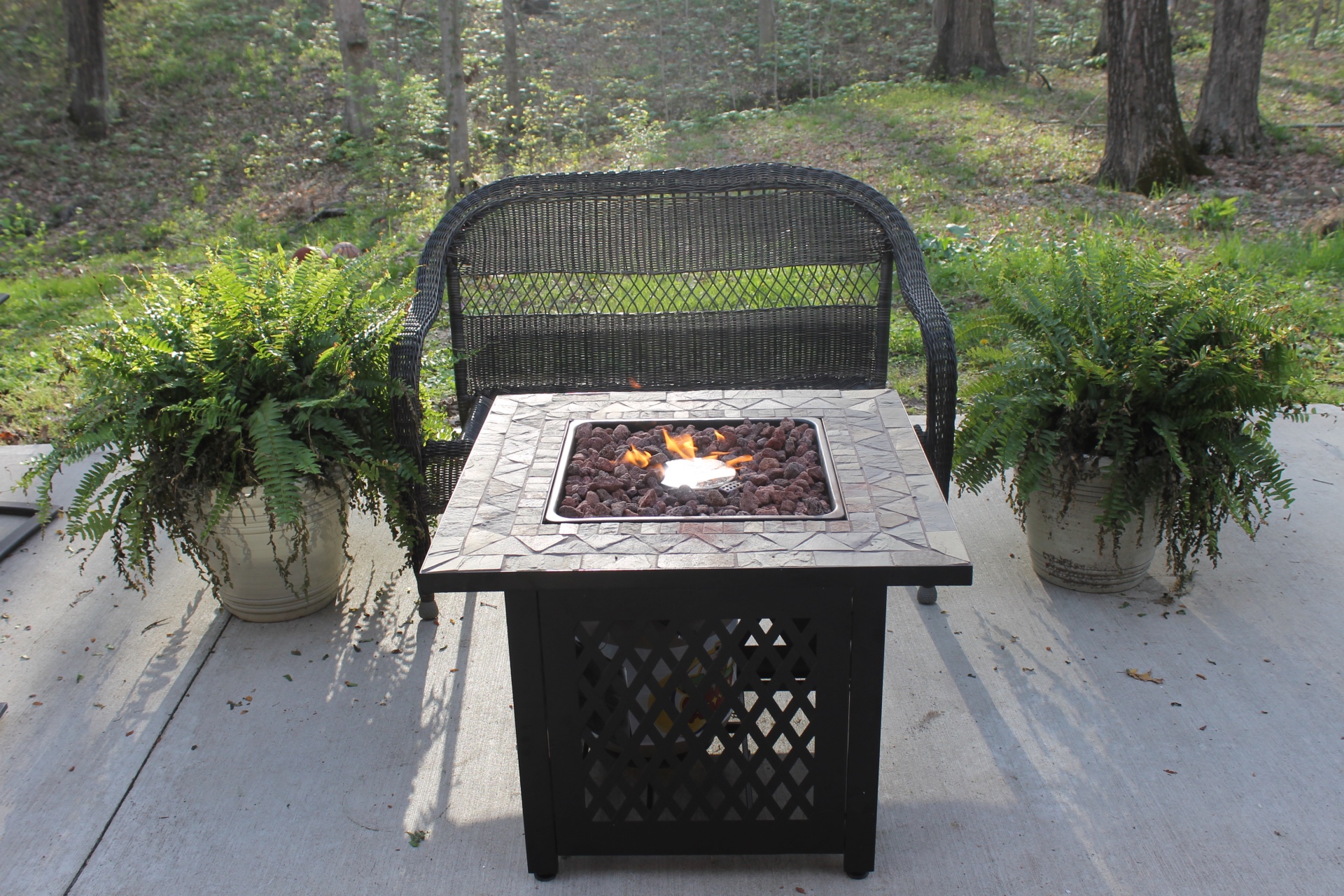 Endless Summer LP Gas Slate Tile Mantel Fire Pit in a garden