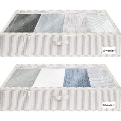 The StorageWorks 2-Pack Underbed Storage Boxes filled with clothing on a white background.