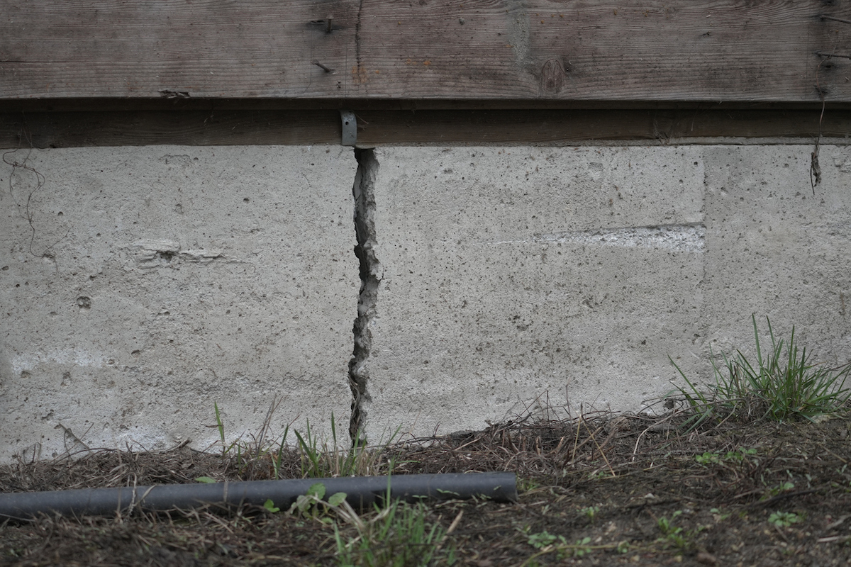 A house's concrete foundation is cracked.